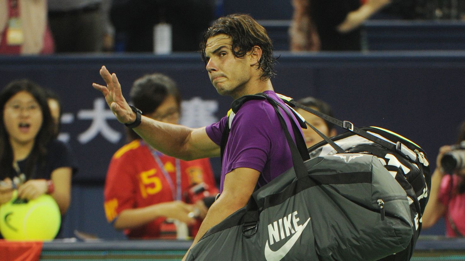Rafael Nadal waves goodbye to the crowd after exiting the Shanghai Masters to Florian Mayer