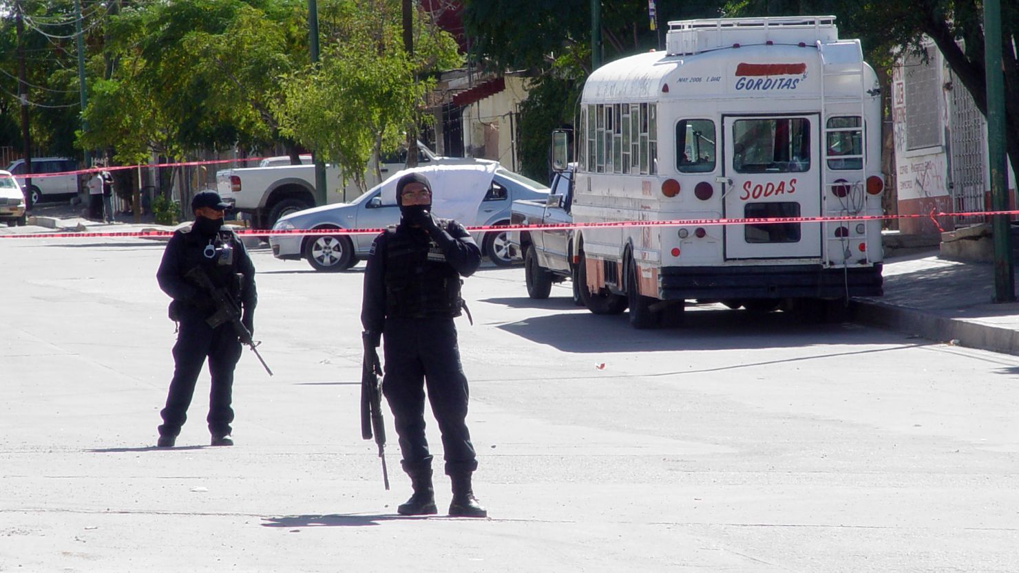 Police respond to the scene where three state prosecutors were killed in front of a school in Juarez, Mexico, on Wednesday.