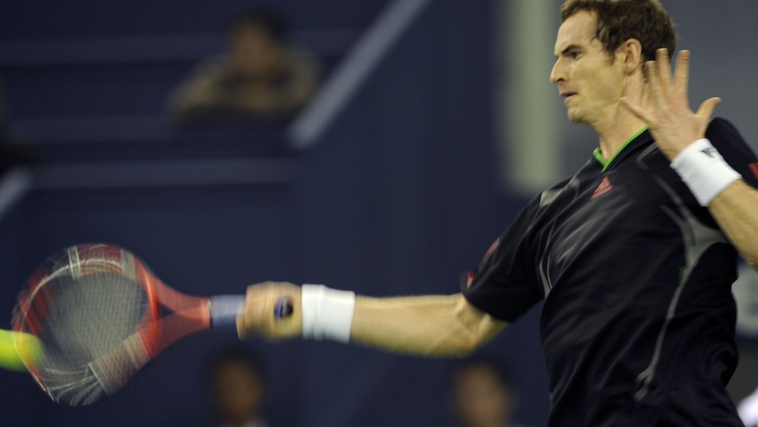 Defending champion Andy Murray returns a shot against Matthew Ebden of Australia at Qizhong Tennis Center.
