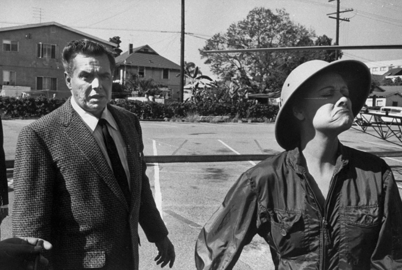 Ball makes one of her classic funny faces as Arnaz follows behind. 
