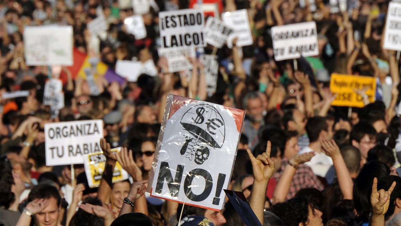 Protesters demonstrate in Madrid, on October 15, 2011, during a worldwide demonstration against corporate greed and government cutbacks. 
