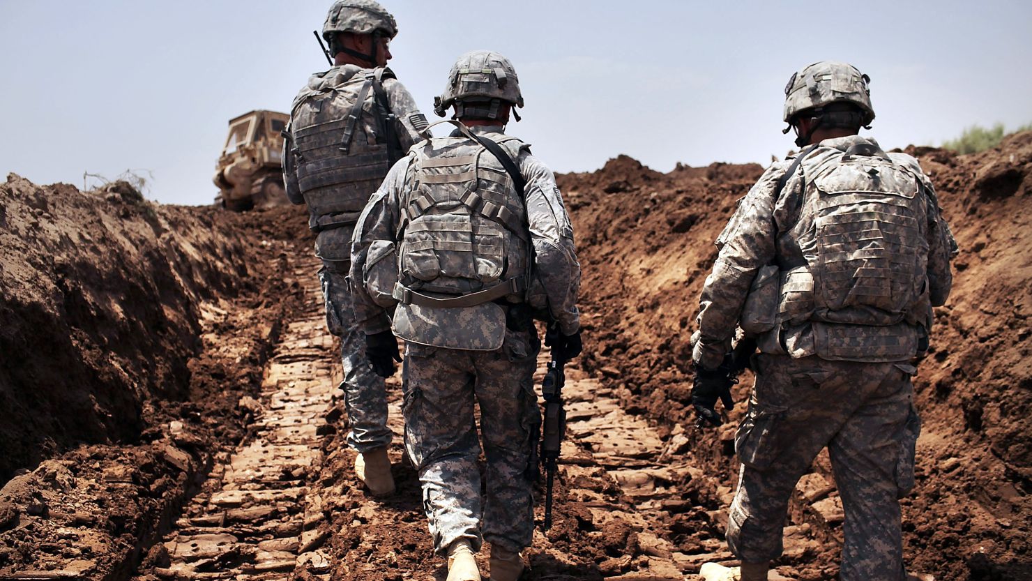 U.S. soldiers patrol a a newly dug ditch in Iraq. The country's leaders said U.S. soldiers won't receive Iraqi immunity after 2011.
