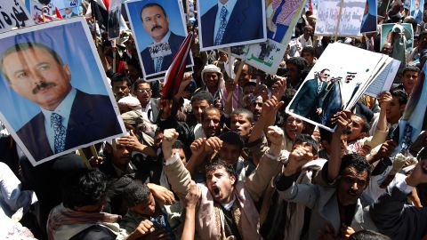 Supporters of  Ali Abdullah Saleh chant pro-regime slogans during a rally after the Friday noon prayers in Sanaa on October 14