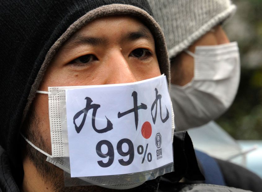 A Japanese protestor wears a mask that says "we are 99 percent" during a Saturday protest in Tokyo.