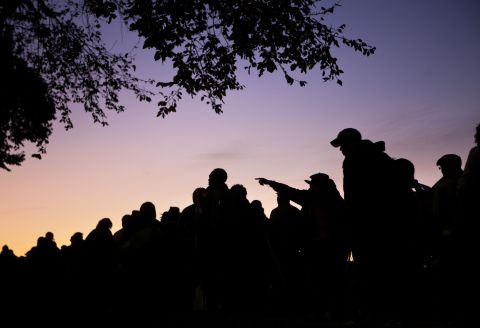 People wait in line at sunrise for the dedication ceremony at the Martin Luther King Jr. National Memorial on the National Mall in Washington on Sunday, October 16.