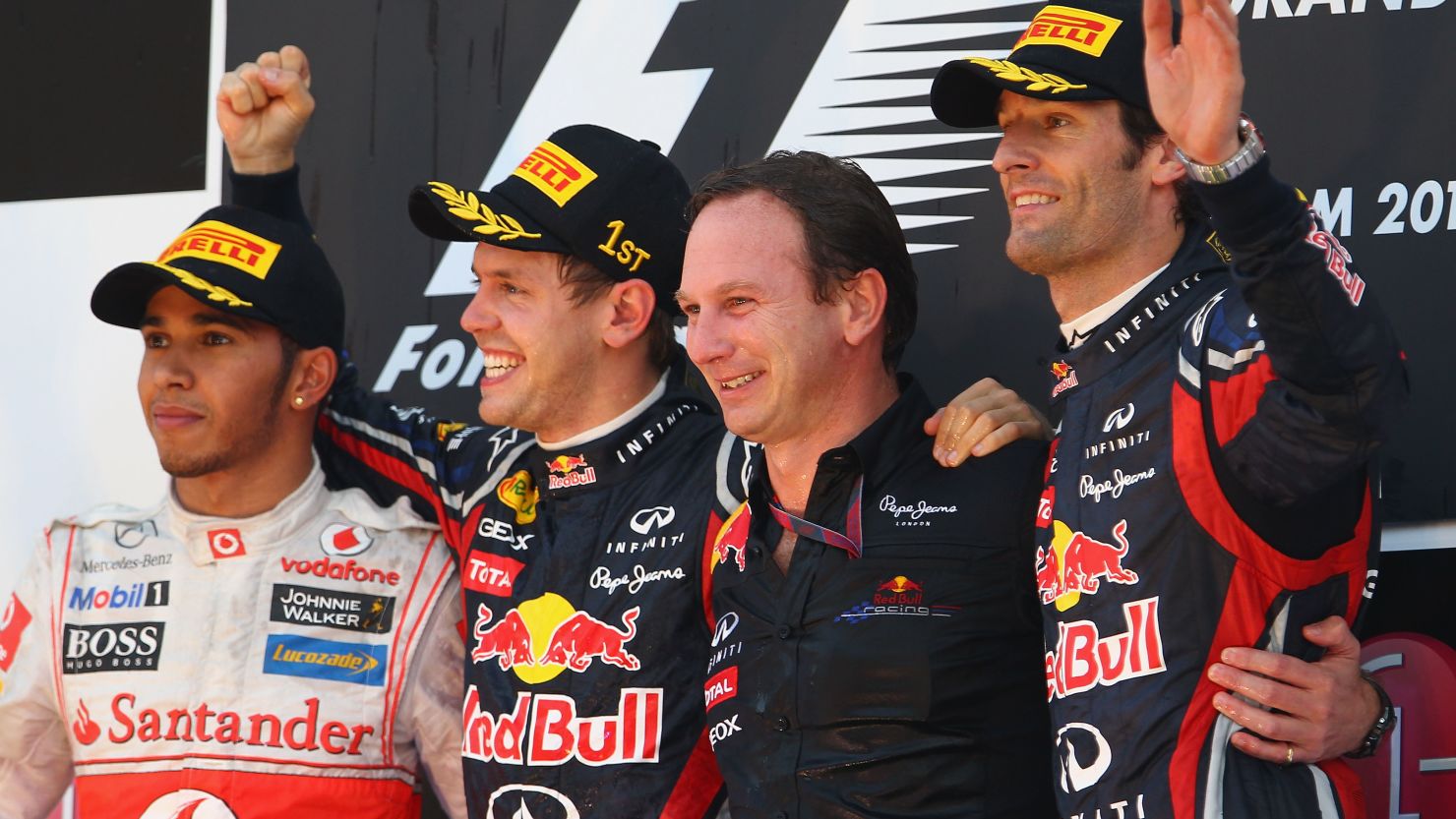 Sebastian Vettel and Mark Webber flank team principal Christian Horner after Red Bull's triumph.