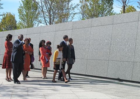 The Obama family toured the memorial before the president's speech. Obama walks with his daughters Sasha, left, and Malia.