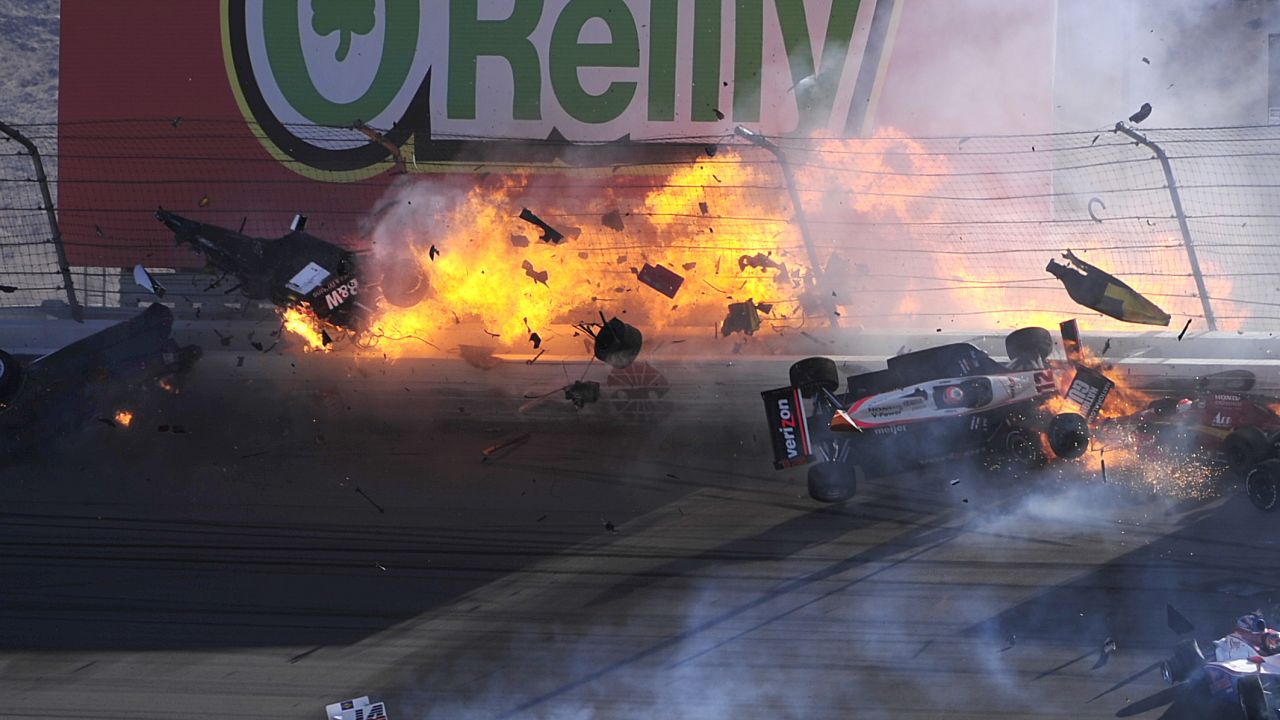 The car of Dan Wheldon disintegrates and bursts into flames in a 15-car pileup during Sunday's Las Vegas Indy 300. 