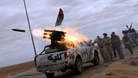 NTC fighters launch a rocket toward the desert city of Bani Walid on October 11, 2011.