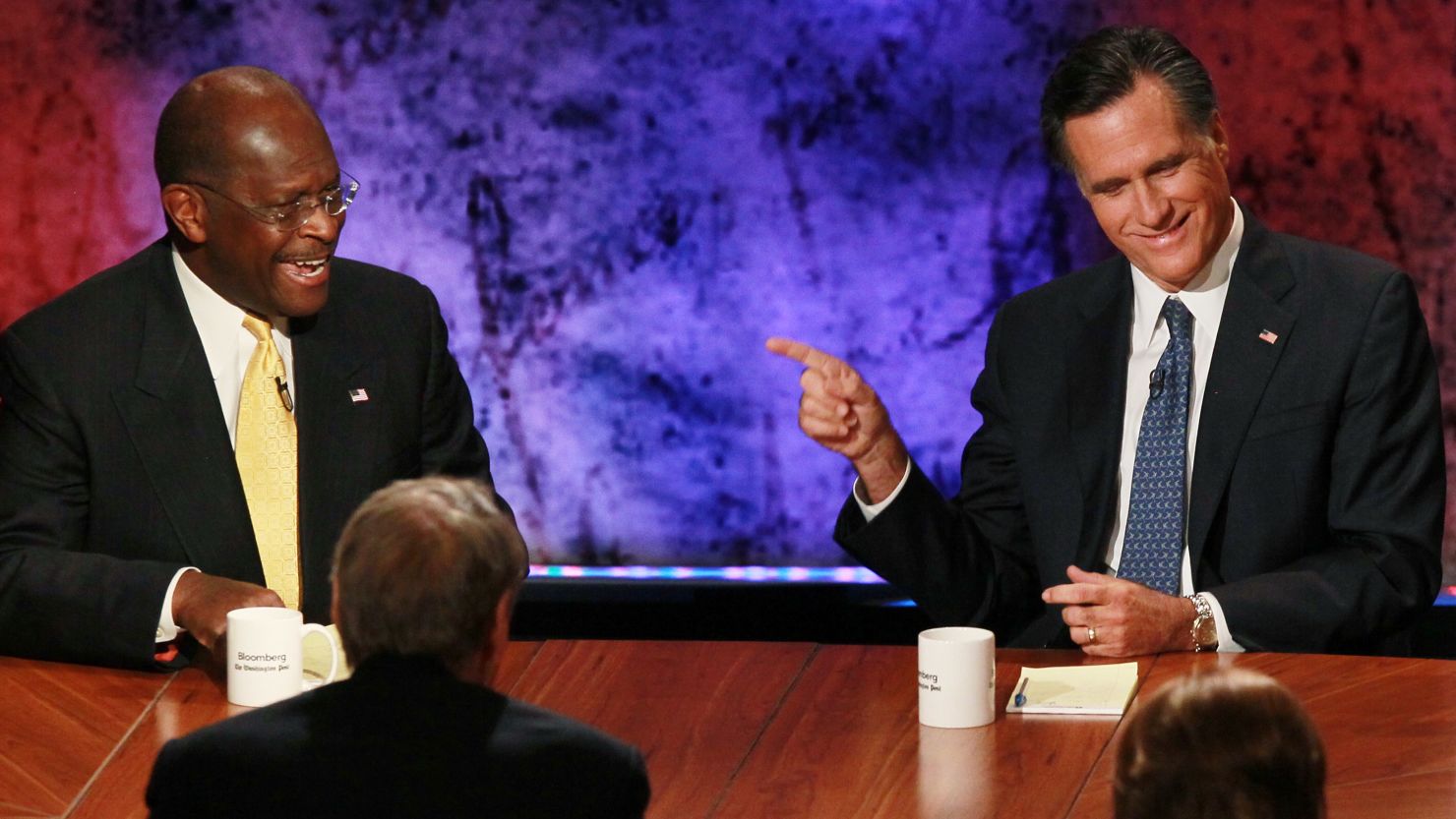 Mitt Romney, right, and Herman Cain participate in the Republican presidential debate on October 11.