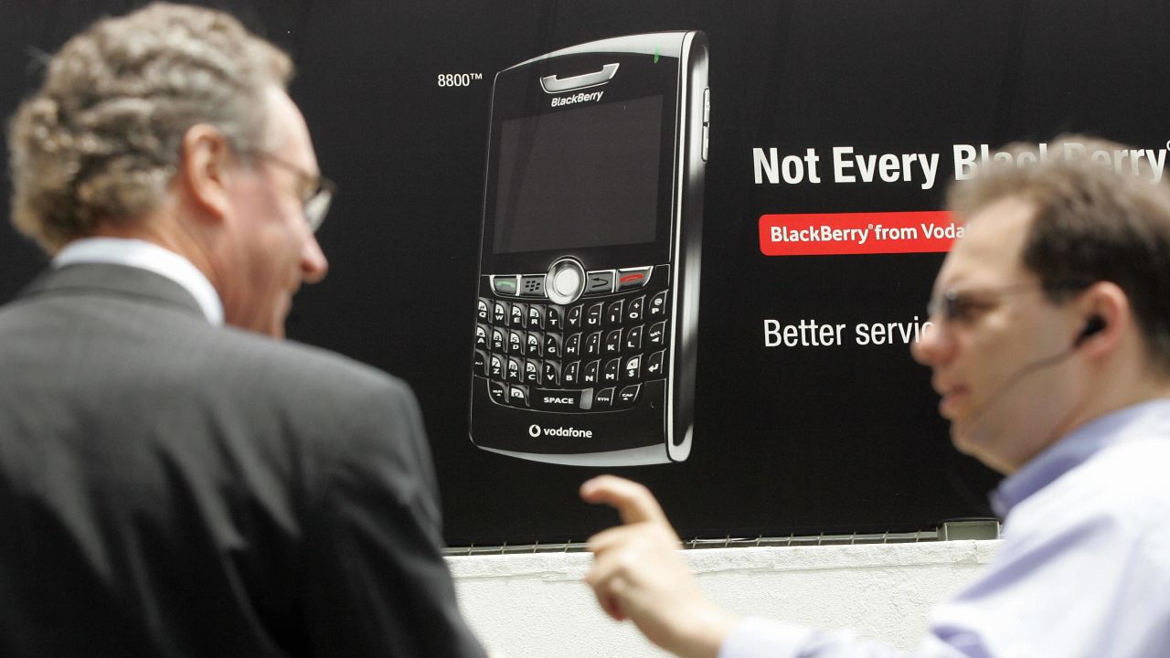 Pedestrians talk in front of a BlackBerry advertisement in Hong Kong in this 2007 photo.