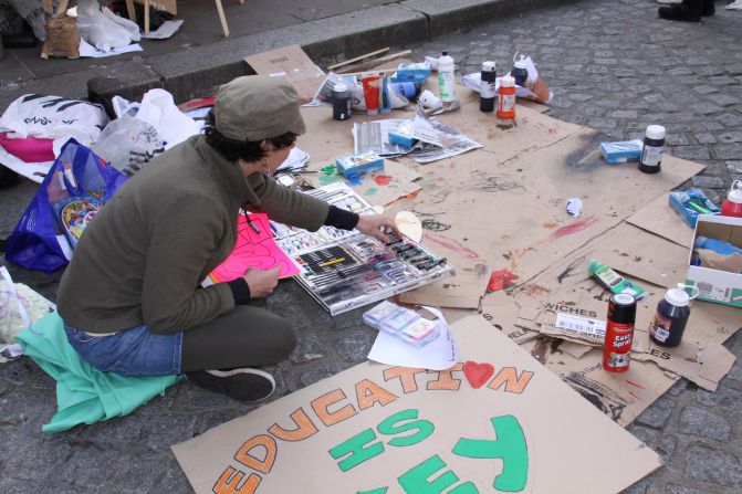 A protester makes banners at the Occupy London demonstration at St Paul's Cathedral.