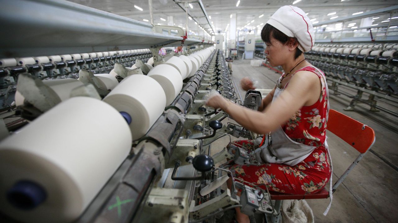 In this photo a worker operates machines for making yarn at a textile factory in Huaibei, east China's Anhui province.