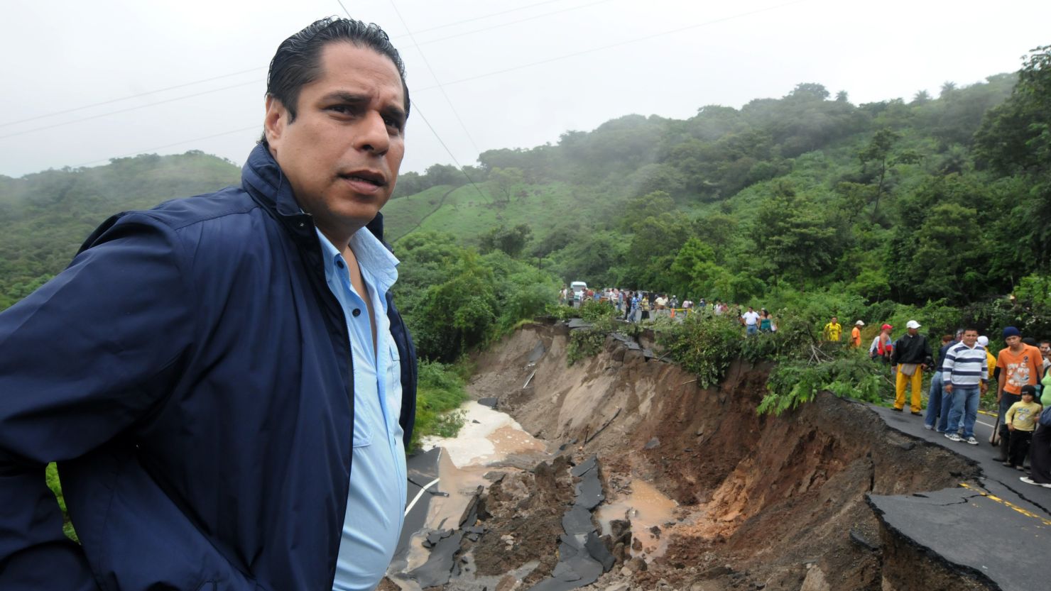 Honduran official Miguel Rodrigo Pastor checks landslide damage on the Pan-American highway near La Moramulca.