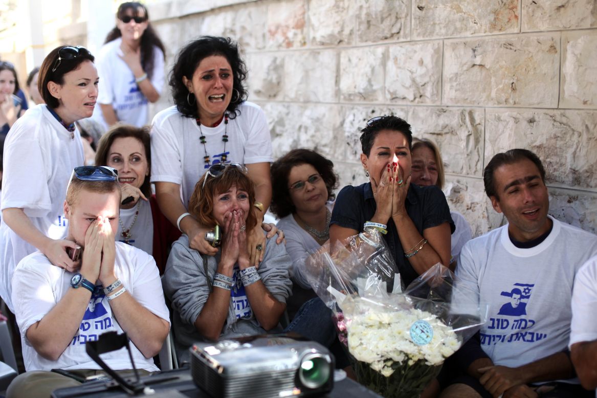 Supporters of Shalit celebrate his release at his family's protest tent outside the prime minister's residence in Jerusalem. 