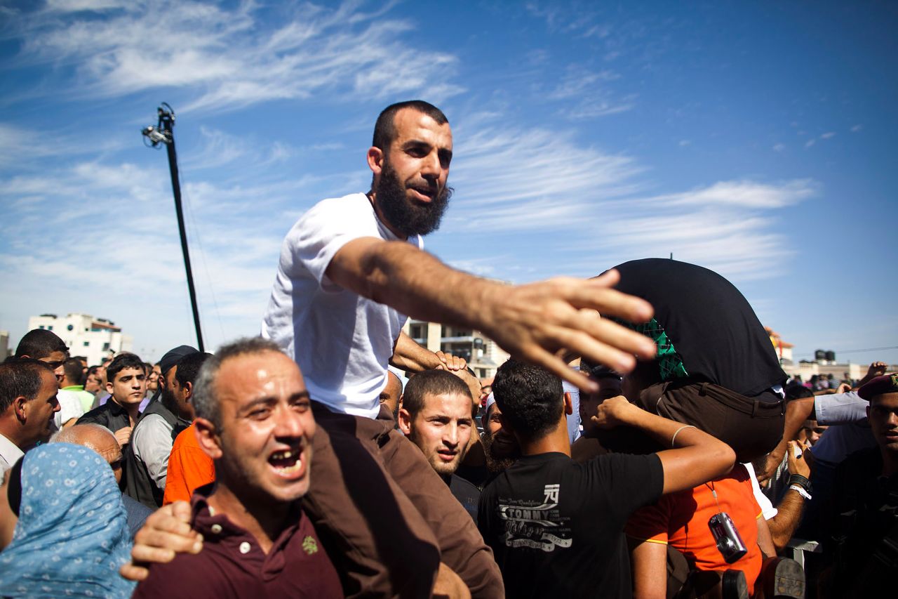 A Palestinian prisoner celebrates with relatives after being freed on Tuesday.
