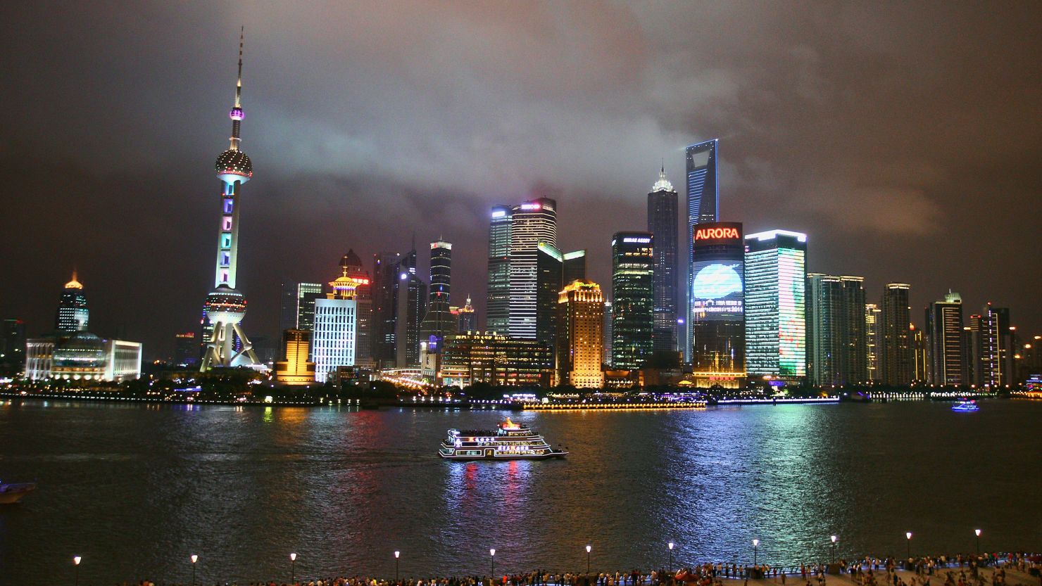 File photo of a sightseeing ship on the Huangpu River against the night skyline of Shanghai's financial district on July 15.
