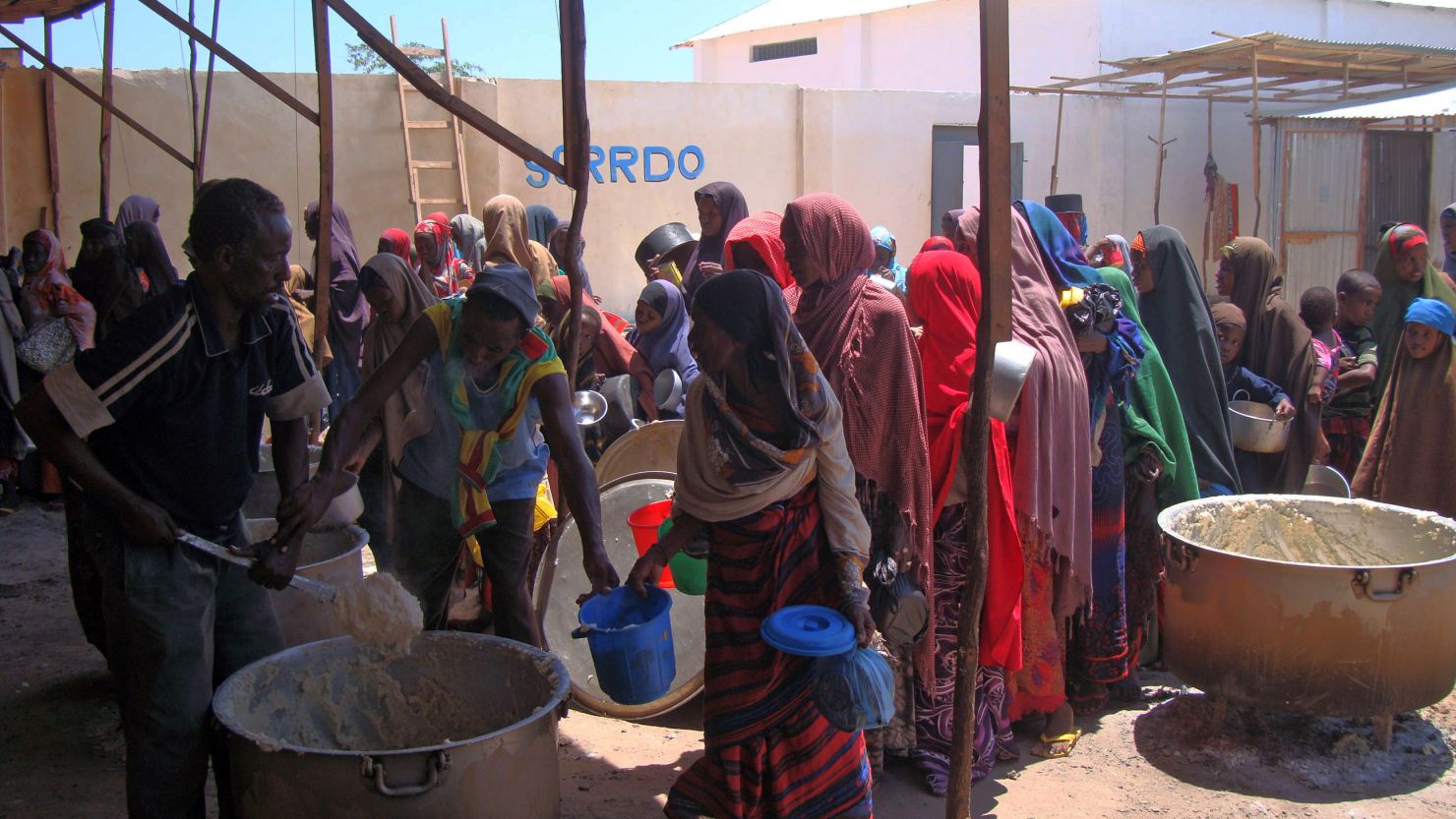 Displaced Somali women line up for food rations Monday at a feeding center in southern Somalia. 