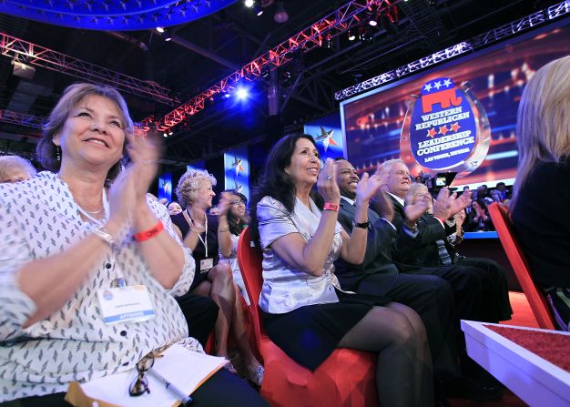 The audience claps as CNN's Anderson Cooper introduces the candidates. 