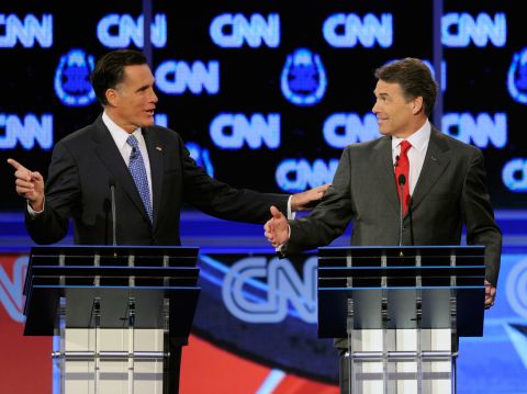 Former Massachusetts Gov. Mitt Romney, left, and Texas Gov. Rick Perry clash over the topic of immigration during the presidential debate on Tuesday, October 18, in Las Vegas. Romney criticized Perry for interrupting him.