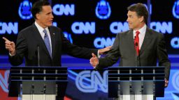 Former Massachusetts Gov. Mitt Romney, left, and Texas Gov. Rick Perry clash over the topic of immigration during the presidential debate on Tuesday, October 18, in Las Vegas. Romney criticized Perry for interrupting him.