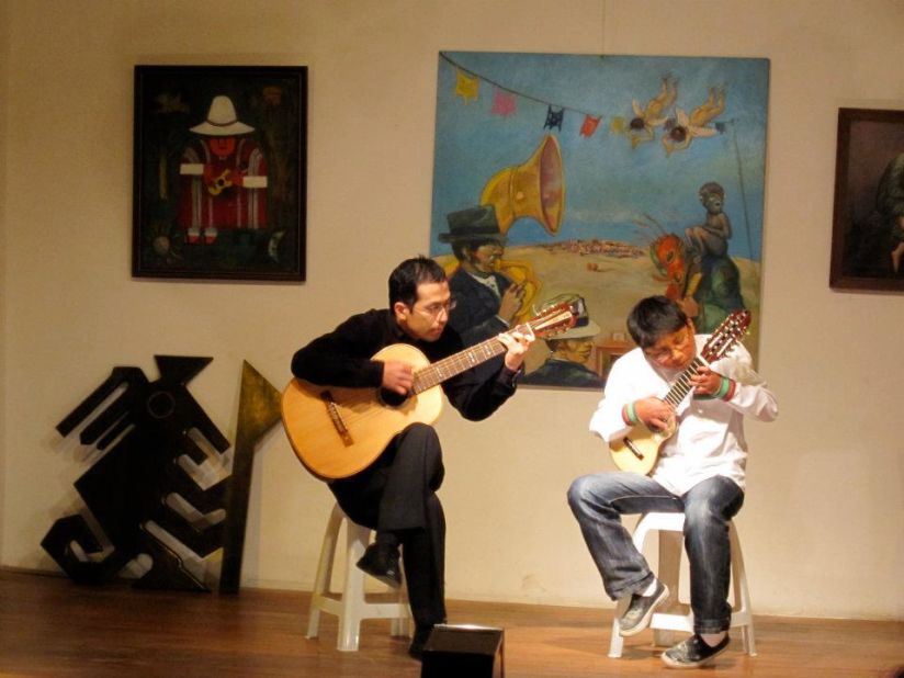 One of the youngest students of the Museo de Instrumentos Musicales de Bolivia plays the charango. The school often puts on Saturday night performances.