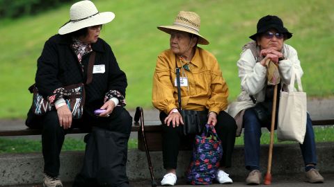 Senior citizens take a break on a bench during the 8th Annual Healthy Living Festival this summer in Oakland, California. 