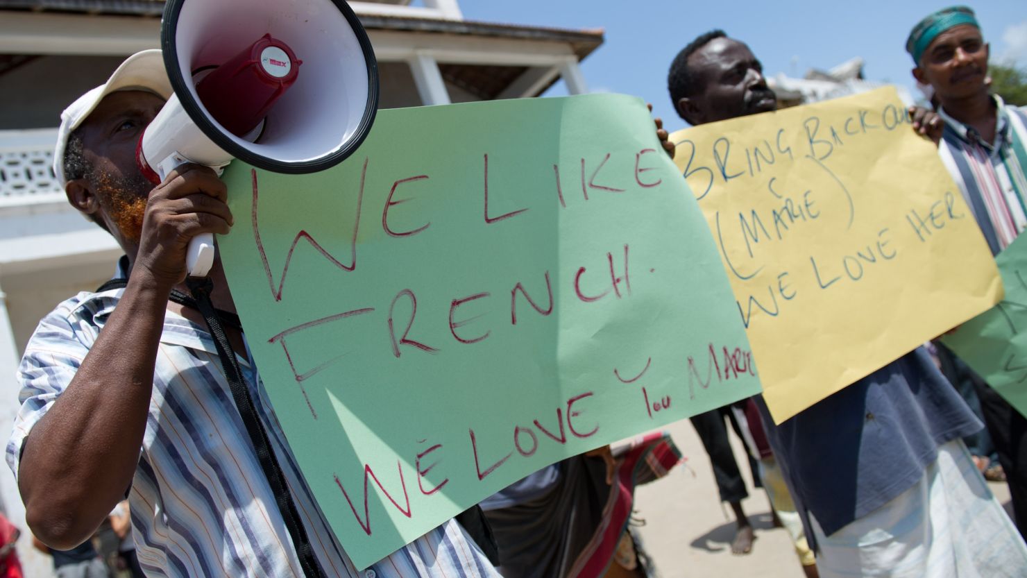 Local Kenyan hoteliers hold placards supporting the return of kidnapped Marie Dedieu earlier this month. 