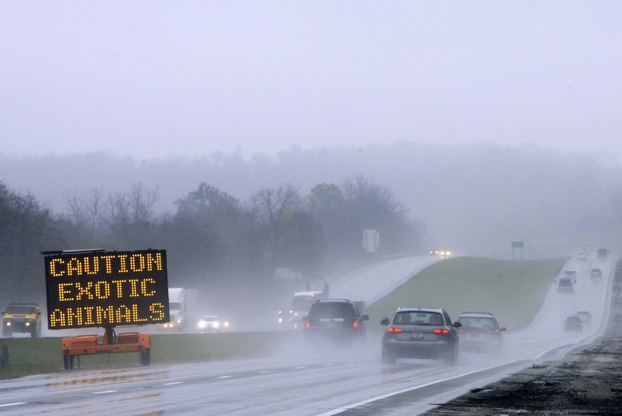 A sign warns drivers of the exotic animals loose outside Zanesville, Ohio, on Wednesday, October 19. It appears that Terry Thompson, 62, released 56 animals and then died from a self-inflicted wound, an official said.