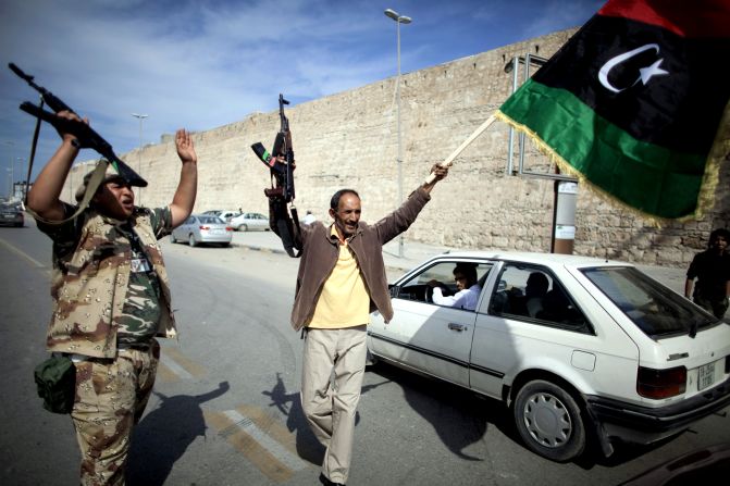 Libyan National Transitional Council fighters celebrate in the streets of Tripoli after news of Moammar Gadhafi's capture in Sirte on Thursday, October 20.