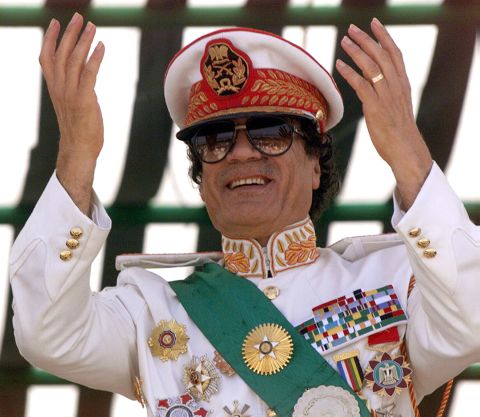 Gadhafi salutes during a 1999 military parade celebrating the 30th anniversary of the Libyan Revolution in Tripoli.