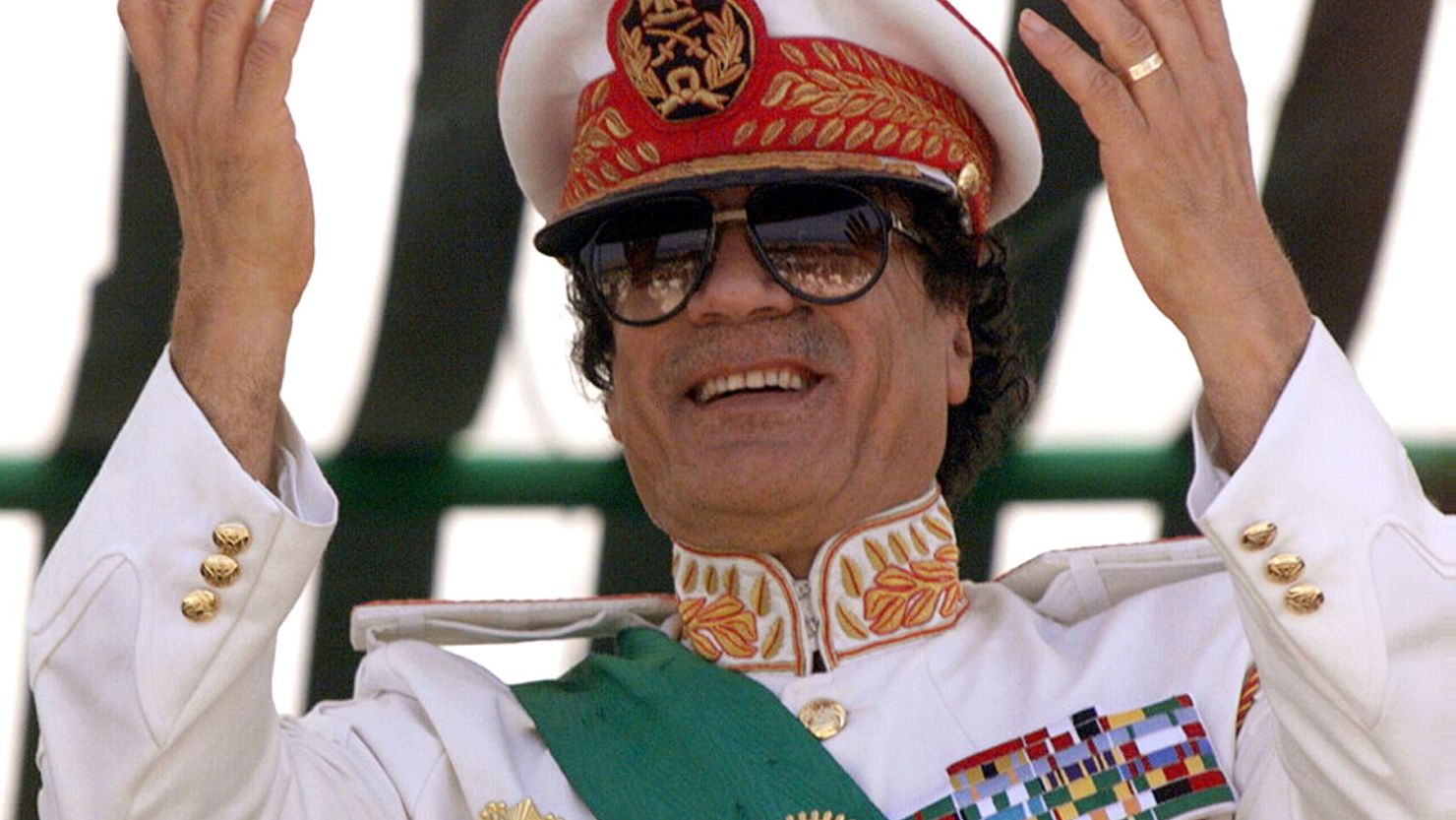 Moammar Gadhafi salutes his troops at a 1999 parade to mark the 30th anniversary of the revolution that brought him to power.