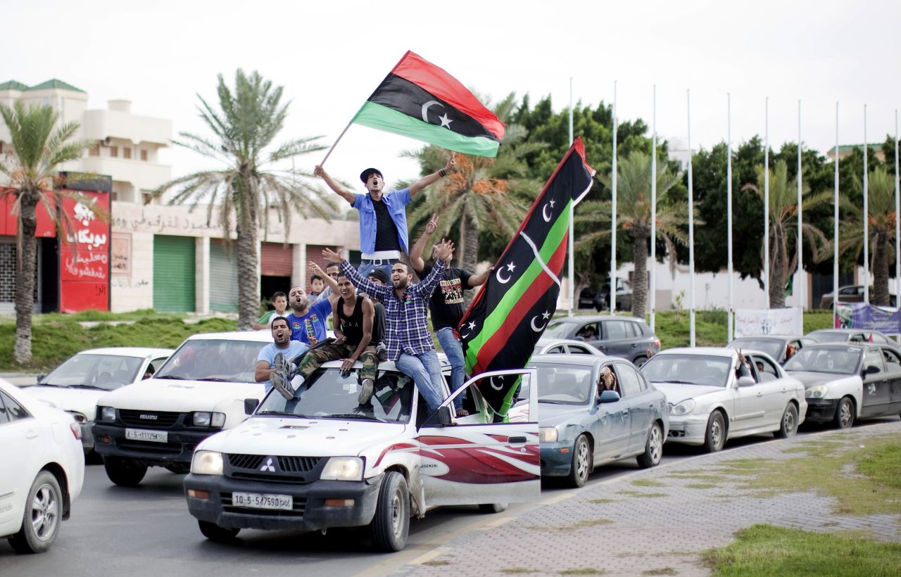 Libyans waving NTC flags celebrate in the streets of Tripoli on Thursday after news of Moammar Gadhafi's capture.