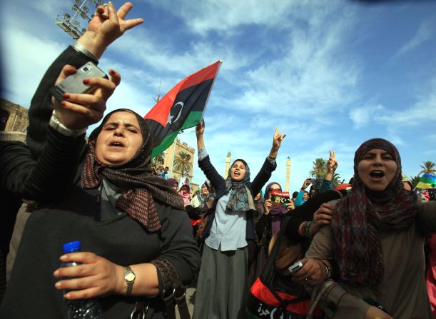 Libyans wave their new national flag as they celebrate in Tripoli. Interim Prime Minister Mahmoud Jibril told reporters Thursday that Gadhafi had been killed.