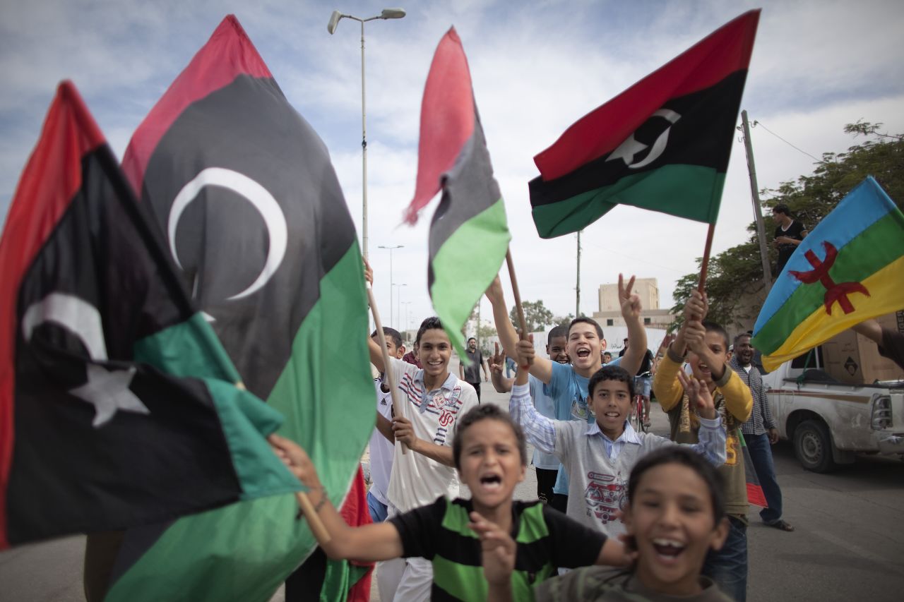 Libyan children wave NTC flags in Tripoli. "Libya is now under the full control of National Transitional Council forces," Catherine Ashton, the European Union foreign policy chief, said Thursday.