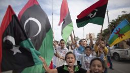 Libyan children waving National Transitional Council (NTC) flags celebrate in the streets of Tripoli following news of Moammar Gadhafi's capture on October 20, 2011. MARCO LONGARI/AFP/Getty Images