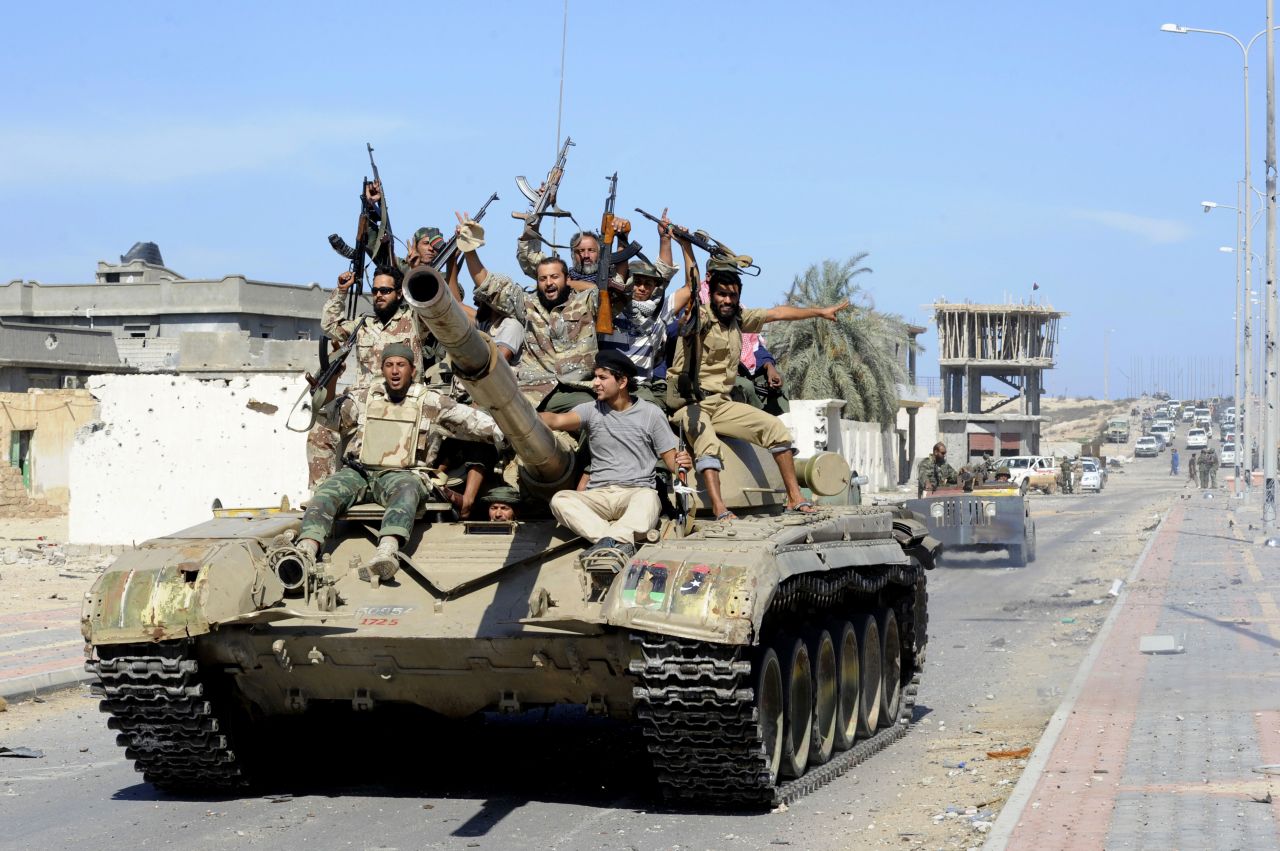 Libyan National Transitional Council fighters celebrate atop a tank in the coastal city of Sirte on Thursday.
