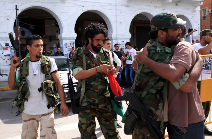 Libyan NTC fighters are congratulated Thursday during celebrations in the streets of Tripoli after news of Moammar Gadhafi's capture.