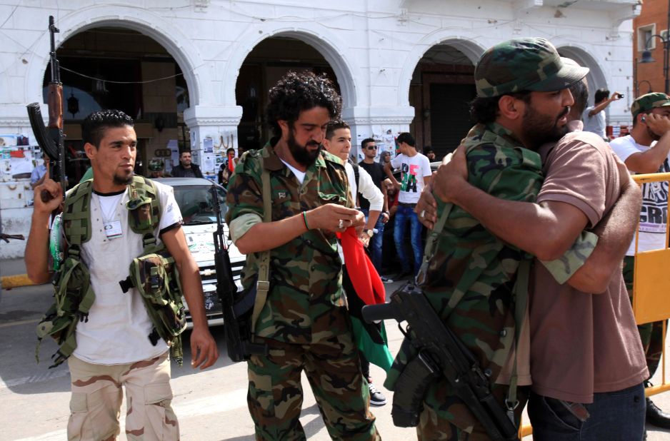 Libyan NTC fighters are congratulated Thursday during celebrations in the streets of Tripoli after news of Moammar Gadhafi's capture.