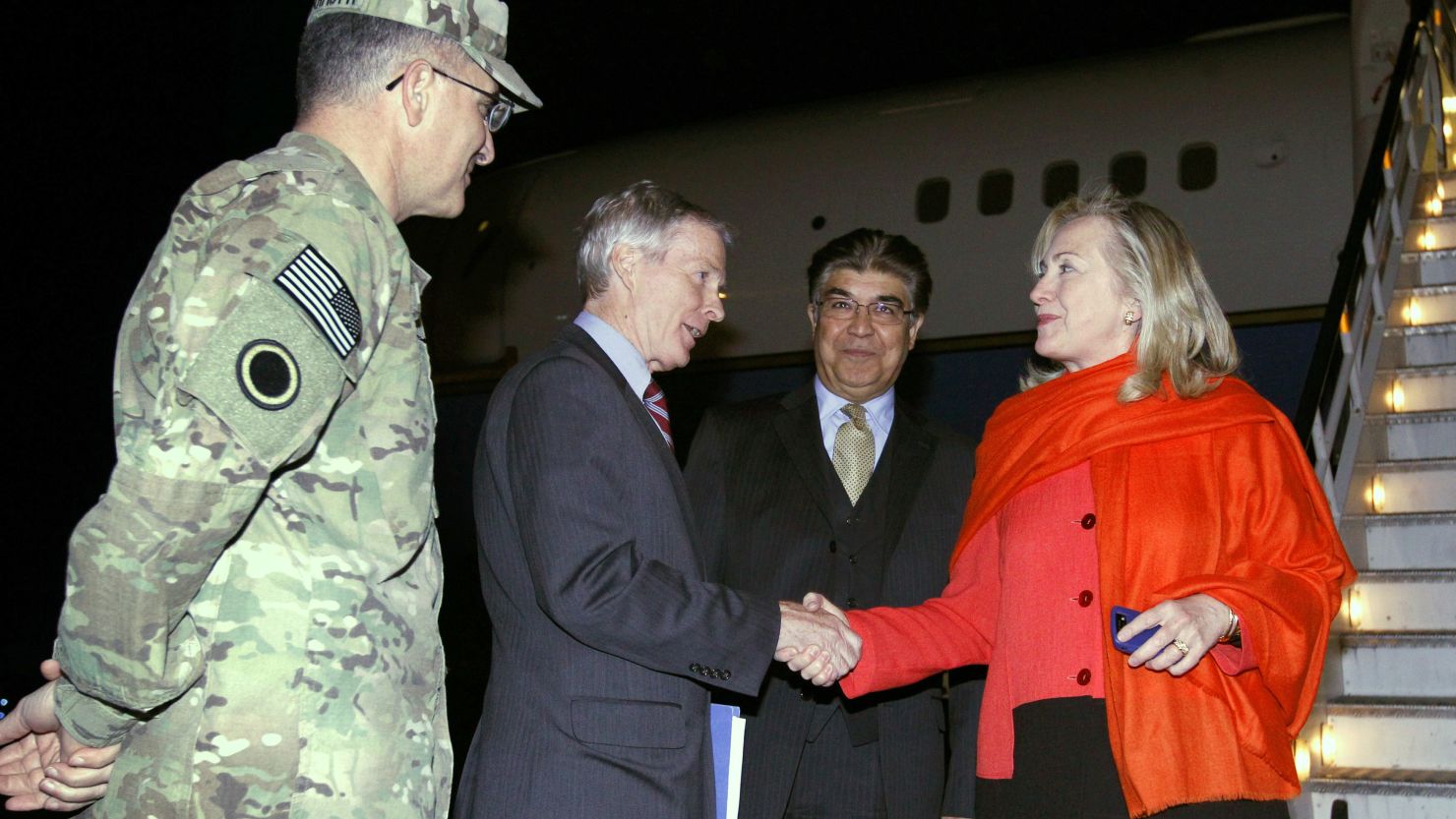 Ryan Crocker, U.S. ambassador to Afghanistan, greets Secretary of State Hillary Clinton upon her arrival in Kabul. 