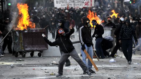 Police clash with masked demonstrators in Athens on October 20,  where tens of thousands of protesters rallied.