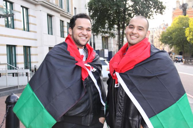 Two Libyan students wore their nation's new flags as capes when they joined in the party-like atmosphere at the embassy, in central London.