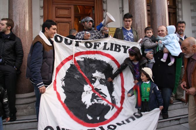 Others proudly waved an anti-Gadhafi banner as passing cars beeped their horns in solidarity.