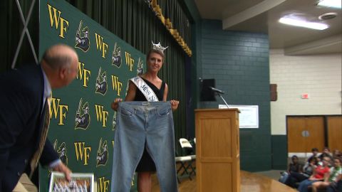 Bree Boyce, who is Miss South Carolina holds a pair of size 18 jeans she wore in high school. 