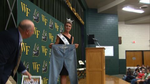 Bree Boyce, who is Miss South Carolina holds a pair of size 18 jeans she wore in high school.