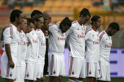 AC Milan players hold a minute's silence for Simoncelli before the start of their Serie A match Sunday.