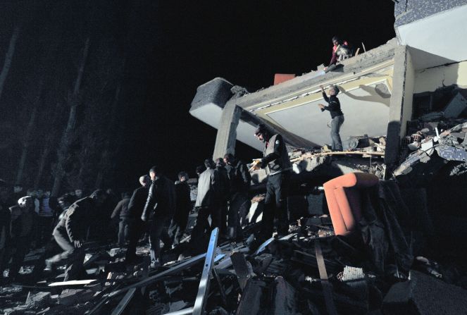 Men scour the rubble on Sunday looking for survivors.