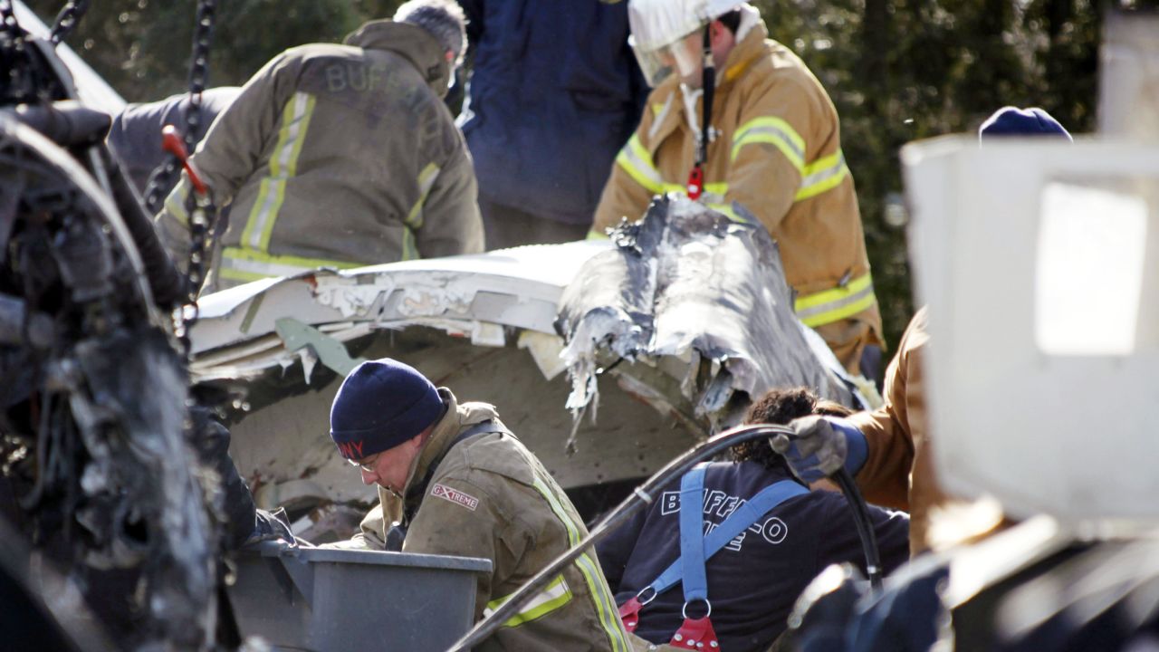 Investigators and rescue workers sift through the debris of Continental Connection Flight 3407 in 2009.