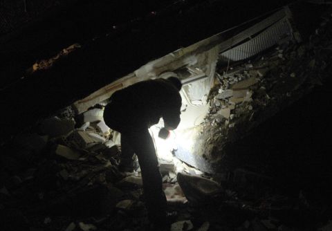 A Turkish man searches for survivors in the rubble on Sunday.