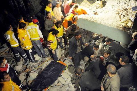 Citizens and rescue workers sift through the rubble looking for survivors in Ercis, Turkey, on Sunday.